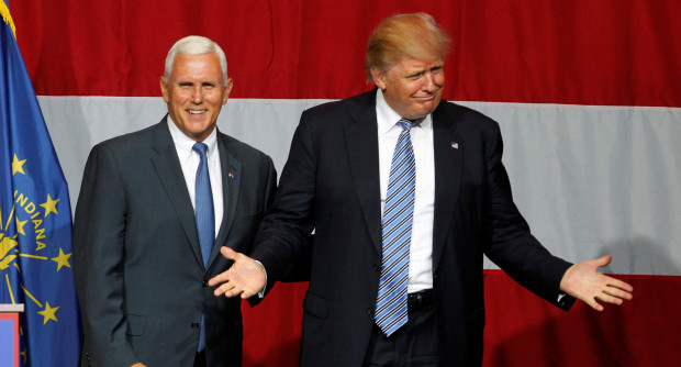 Republican U.S. presidential candidate Donald Trump (R) and Indiana Governor Mike Pence (L) wave to the crowd before addressing the crowd during a campaign stop at the Grand Park Events Center in Westfield, Indiana, July 12, 2016. REUTERS/John Sommers II - RTSHNE6
